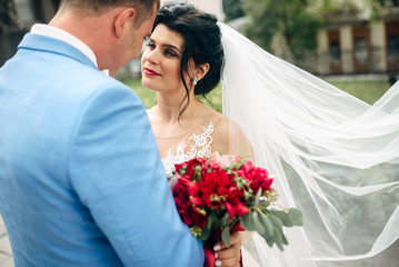 Bride is looking with love on her groom