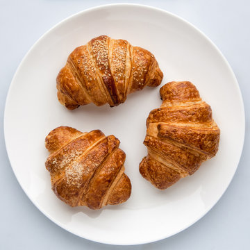 croissants in a plate on a white background top view