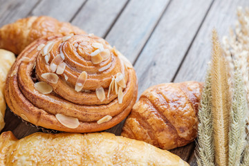 fresh bread and baked goods on wooden chopping board, rustic style
