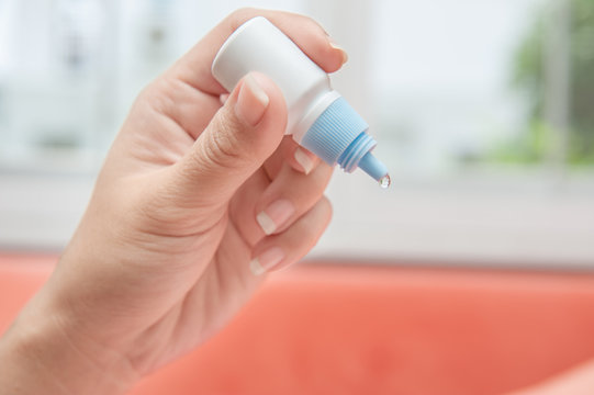 Hand With Eye Drop Bottle