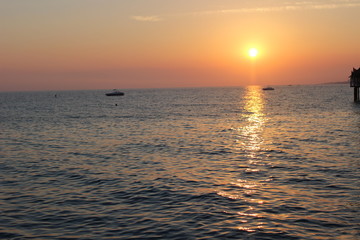 Fototapeta premium sunset on the beach, romantic time, lovelu sky, ocean, dusk, clouds, romantic, lovely , bridge, colors, 