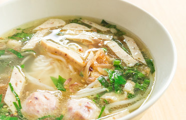 Vietnamese soup Pho Bo with vegetables and rice noodles in a bowl
