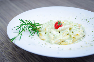 Pasta penne with basil and chicken meat