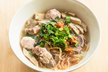 Vietnamese soup Pho Bo with vegetables and rice noodles in a bowl