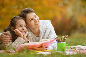 girl with her grandmother reading