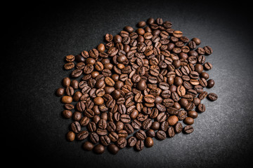 Roasted coffee beans on dark background. Selective focus.