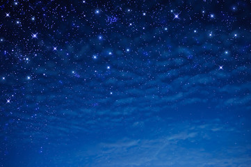 stars in the blue sky at night with clouds