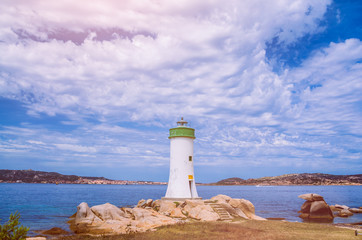 White lighthouse and cloudscape. Sardinia Island, Italy