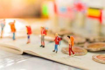 Miniature people : Backpacker travel to destinations on the coin. Using as travel business concept