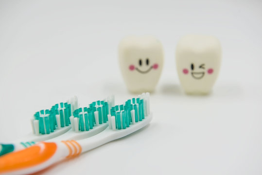 New toothbrush and Model Cute toys teeth in dentistry on a white background.