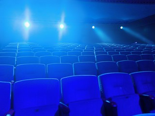 Naklejka premium Empty movie theater with projection light falling into the lens 