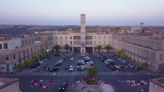 flying towards fascist symbol on Guardia di Finanza tower in Ragusa