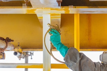 Painted, corroded, anti-corrosion, with spray guns on the production platform to extend the life of materials, Energy and petroleum industry sea offshore