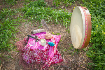 Altar and drum with drumstick and symbols of essential elements