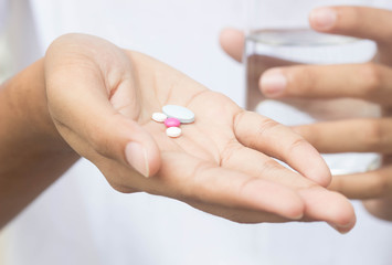 Medicine pills in hand , selective focus