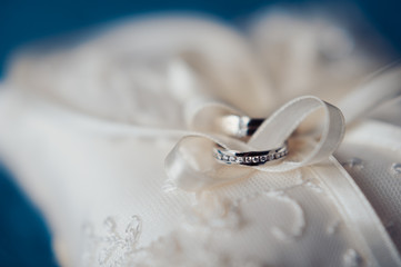 Two wedding rings on the pillow