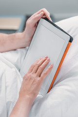 cropped shot of female and male hands holding tablet