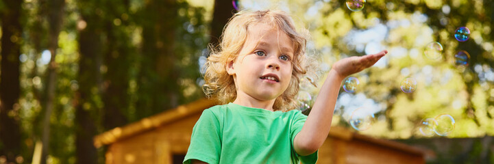 Little boy playing with soap bubbles