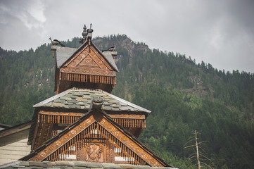 Wooden roof of the temple of Durga, in the background of the Himalayas