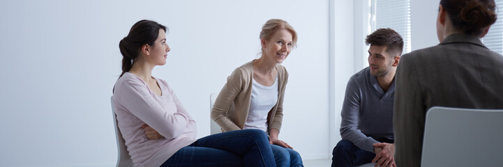 Smiling therapist speaking to group