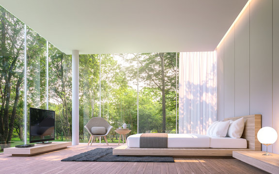 Modern bedroom with garden view in the morning 3d rendering image.There are large window overlooking the surrounding garden and nature and finished with wooden furniture