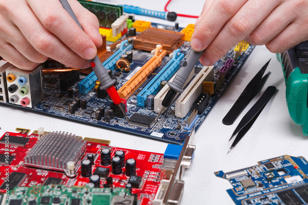 Poster engineer checking motherboard with multimeter