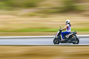 Adult Woman Driving Scooter at Outdoor