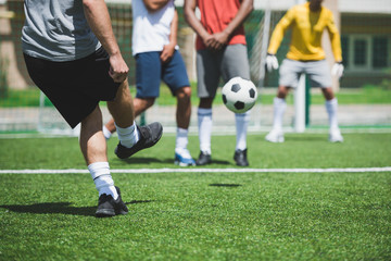 Fototapeta premium cropped shot of group of soccer players during soccer match on pitch