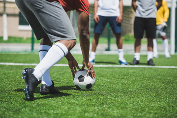 partial view of group of soccer players during soccer match on pitch