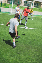 group of multiethnic soccer players during soccer match on pitch