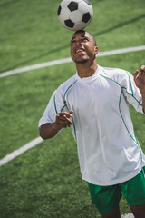 african american soccer player holding ball on head during game © LIGHTFIELD STUDIOS