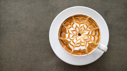 Top view of hot coffee cappuccino latte art top view on concrete table background