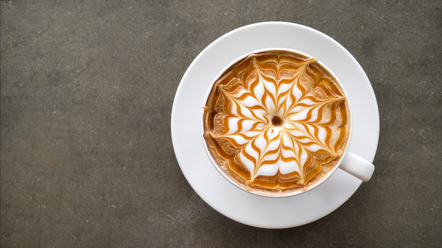 Top view of hot coffee cappuccino latte art top view on concrete table background