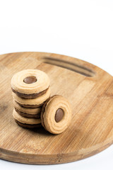 Round chocolate cookies on the wooden board