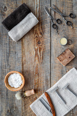 Barbershop. Men's shaving and haircut. Brush, razor, foam, sciccors on wooden table background top view copyspace