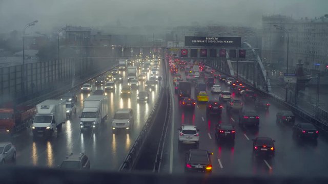 Rain in Moscow. View to traffic on the bridge