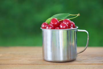 Cherries in iron cup on table