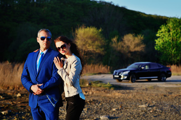 Business man and girl looking at the sunset