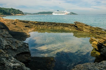 Reflection in the beach with cruise in the background