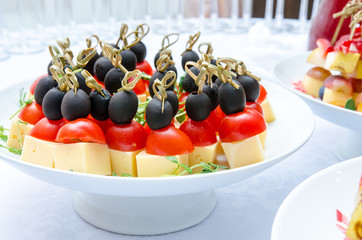 Set of delicious canapes with cheese, cherry tomatos and olive