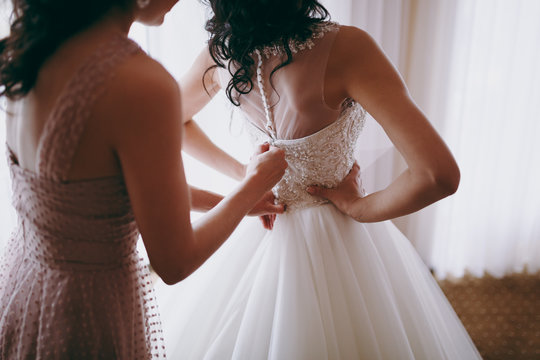 Fashionable Bridesmaids Dresses Helped Wear Bow On Back Of Wedding Dress Bride. Morning Wedding Day.