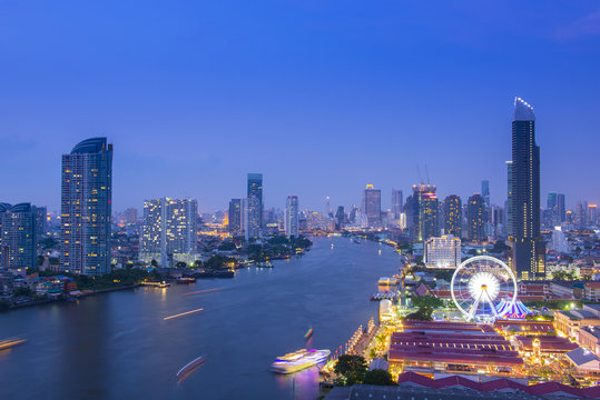 Bangkok city skyline at night. The Ferris wheel and shopping place are very famous location for tourist. This location is near by Chao Phraya river can access by shuttle boat and bus.