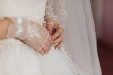 Hands and feet of the bride. Close-ups, hands together, fingers