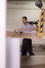 worker in a factory of wooden furniture