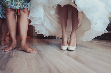 Bride Putting On Wedding Shoes