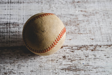 old Baseball and glove on wood background with filter effect retro vintage style