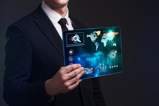 Business, Technology, Internet and network concept. Young businessman working on a virtual screen of the future and sees the inscription: Internal audit