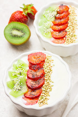 Breakfast bowl with yoghurt, strawberry, kiwi and green buckwheat.
