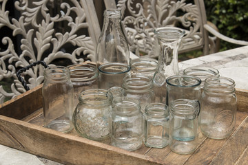Clear glass jars for food preservative on wooden tray