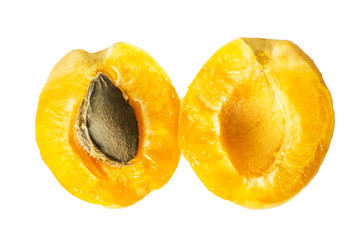 Two halves of a juicy ripe pineapple apricot with a bone inside. Isolated halved fruit on a white background. Top view.